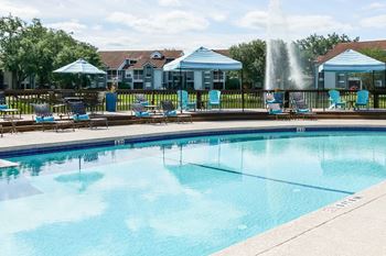 Pool with cabana and chairs